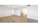 Spacious living room featuring wood floors and an open layout into the kitchen at 4954 Palmyra Ave, Las Vegas, NV 89146