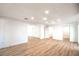 Bright and spacious living room featuring modern lighting and wood flooring at 4954 Palmyra Ave, Las Vegas, NV 89146