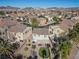 Aerial view of the neighborhood showcasing landscaped backyards with putting greens and desert landscaping at 511 Via Ripagrande Ave, Henderson, NV 89011