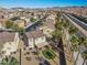 Aerial view of the neighborhood showcasing landscaped backyards, desert landscaping and nearby mountains at 511 Via Ripagrande Ave, Henderson, NV 89011