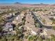 A charming neighborhood with lush landscaping, curved streets, and stunning mountain backdrop at 511 Via Ripagrande Ave, Henderson, NV 89011