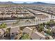 This is an aerial view showcases a well-maintained community, palm-lined streets, and nearby amenities at 511 Via Ripagrande Ave, Henderson, NV 89011