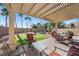 Covered back patio with outdoor seating and a putting green, perfect for entertaining guests at 511 Via Ripagrande Ave, Henderson, NV 89011