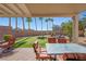 Inviting covered back patio with outdoor seating and a putting green for leisure and relaxation at 511 Via Ripagrande Ave, Henderson, NV 89011