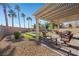 Outdoor backyard featuring an extended patio and putting green perfect for entertaining at 511 Via Ripagrande Ave, Henderson, NV 89011