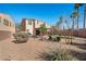 Exterior of home featuring putting green, covered patio, lounge chairs and desert landscaping at 511 Via Ripagrande Ave, Henderson, NV 89011