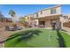 Backyard with a putting green, patio furniture, and landscaped grounds at 511 Via Ripagrande Ave, Henderson, NV 89011