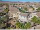 Aerial view of a landscaped backyard featuring a covered patio and putting green at 511 Via Ripagrande Ave, Henderson, NV 89011