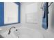 Bright bathroom featuring a large soaking tub and modern window blinds at 511 Via Ripagrande Ave, Henderson, NV 89011