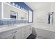 Bright bathroom featuring double vanity, soaking tub, and modern tiled floors at 511 Via Ripagrande Ave, Henderson, NV 89011