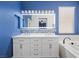 Bathroom featuring double vanity, mosaic backsplash, soaking tub, and bright lighting at 511 Via Ripagrande Ave, Henderson, NV 89011