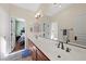 Large bathroom featuring double sinks, decorative tile flooring, and neutral colored walls at 511 Via Ripagrande Ave, Henderson, NV 89011