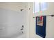 Well-lit bathroom with a shower-tub combo, white tile, and a towel rack with decorative towels at 511 Via Ripagrande Ave, Henderson, NV 89011