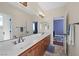 Spacious bathroom featuring double sinks, wood cabinets, and decorative tile flooring at 511 Via Ripagrande Ave, Henderson, NV 89011