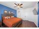 Inviting bedroom featuring blue accent wall, a comfortable bed, and hardwood floors at 511 Via Ripagrande Ave, Henderson, NV 89011