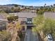 Aerial view of a two-story home featuring desert landscaping, garage and tile roof at 511 Via Ripagrande Ave, Henderson, NV 89011