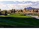 Picturesque golf course with lush green fairways and scenic mountain views in the background at 511 Via Ripagrande Ave, Henderson, NV 89011