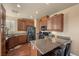 Kitchen with granite counters, dark wood cabinets, stainless steel appliances, and breakfast bar seating at 511 Via Ripagrande Ave, Henderson, NV 89011