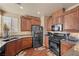 Kitchen featuring stainless appliances, granite counters, wood cabinets, and hardwood floors at 511 Via Ripagrande Ave, Henderson, NV 89011