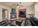 Cozy living room featuring a fireplace, hardwood floors, and comfortable seating at 511 Via Ripagrande Ave, Henderson, NV 89011