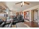 Open concept living room featuring hardwood floors, neutral paint, ceiling fan, and eat-in kitchen at 511 Via Ripagrande Ave, Henderson, NV 89011