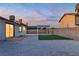 Exterior view of a beautifully landscaped backyard featuring modern white stone and custom entertainment area at 528 Sheffield Dr, Henderson, NV 89014