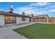 Spacious backyard featuring an entertainment area with low-maintenance artificial grass and a custom shade structure at 528 Sheffield Dr, Henderson, NV 89014