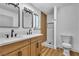 Contemporary bathroom featuring a double sink vanity, wood cabinets, and modern shower at 528 Sheffield Dr, Henderson, NV 89014