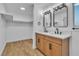 Bright bathroom featuring a double vanity with light wood cabinets and modern fixtures at 528 Sheffield Dr, Henderson, NV 89014