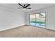 Large, bright bedroom featuring neutral carpet, fresh white walls, and a ceiling fan at 528 Sheffield Dr, Henderson, NV 89014