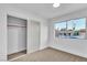 Bedroom featuring neutral carpet, a sliding door closet, and a large window at 528 Sheffield Dr, Henderson, NV 89014