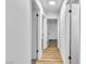 Hallway with multiple doorways, providing access to different rooms with wood look floors at 528 Sheffield Dr, Henderson, NV 89014