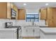 Modern kitchen features white countertops, tile backsplash, stainless steel appliances, and wood cabinets at 528 Sheffield Dr, Henderson, NV 89014