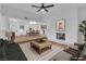 Bright living room featuring a fireplace, ceiling fan, and open access to the dining area and kitchen at 528 Sheffield Dr, Henderson, NV 89014