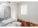 Bathroom featuring a single sink, toilet, and mirror at 557 Liverpool Ave, Henderson, NV 89011