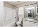 Bathroom featuring a combined shower and tub with a toilet and sink at 557 Liverpool Ave, Henderson, NV 89011