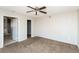 View of a carpeted bedroom featuring neutral walls and a ceiling fan at 557 Liverpool Ave, Henderson, NV 89011