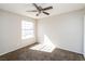 Bright bedroom with a ceiling fan, neutral walls, and sunlit carpet at 557 Liverpool Ave, Henderson, NV 89011