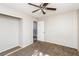 Bedroom with ceiling fan, closet, carpet, and door to a staircase at 557 Liverpool Ave, Henderson, NV 89011