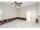 Partially renovated living room featuring tile flooring and sliding glass door access at 557 Liverpool Ave, Henderson, NV 89011