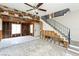 Partially renovated living room with tile floor, stairs and exposed framework at 557 Liverpool Ave, Henderson, NV 89011