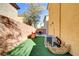 Cozy backyard with artificial turf, toys, and wood fence, perfect for outdoor play and relaxation at 569 Brompton St, Las Vegas, NV 89178