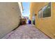 Paver backyard with a view of the sky between two houses, perfect for relaxation and gardening at 569 Brompton St, Las Vegas, NV 89178