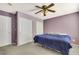 Carpeted bedroom features a ceiling fan and ample closet space at 569 Brompton St, Las Vegas, NV 89178