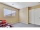 Small carpeted bedroom has a closet with sliding doors and a window at 569 Brompton St, Las Vegas, NV 89178