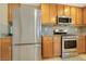 Kitchen boasts stainless steel appliances, wood cabinets, and tile flooring at 569 Brompton St, Las Vegas, NV 89178