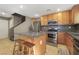 Cozy kitchen with stainless steel appliances, a central island and a staircase at 569 Brompton St, Las Vegas, NV 89178