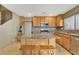 Bright kitchen with wooden cabinets, stainless steel appliances, granite countertops, and center island at 569 Brompton St, Las Vegas, NV 89178