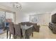 Living room and dining area with tile floors, a large sectional and sliding glass doors at 569 Brompton St, Las Vegas, NV 89178