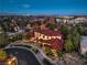 Luxury home with red tile roof and professional landscaping nestled in a well-planned Las Vegas community at dusk at 6 Fire Rock Ct, Las Vegas, NV 89141